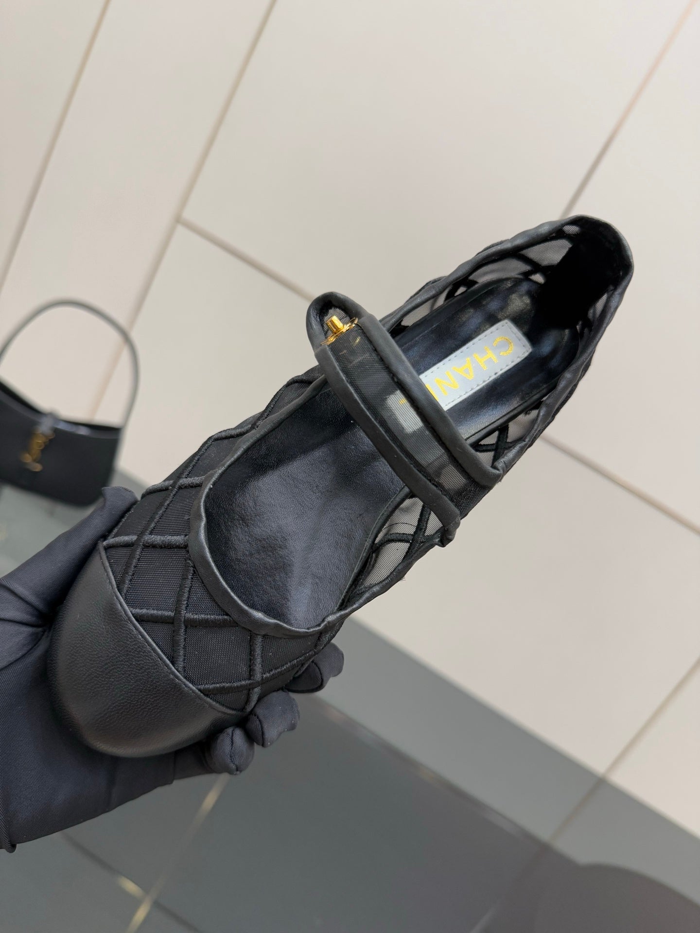 Chanel women’s black quilted flats, interior view showing label at opening