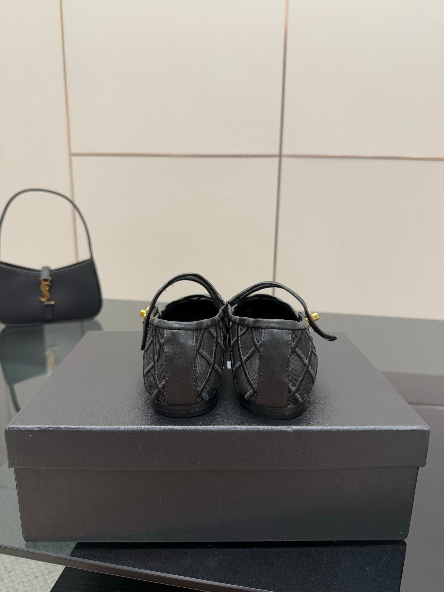 Chanel women’s black quilted flats, rear view with slim straps and gold tag