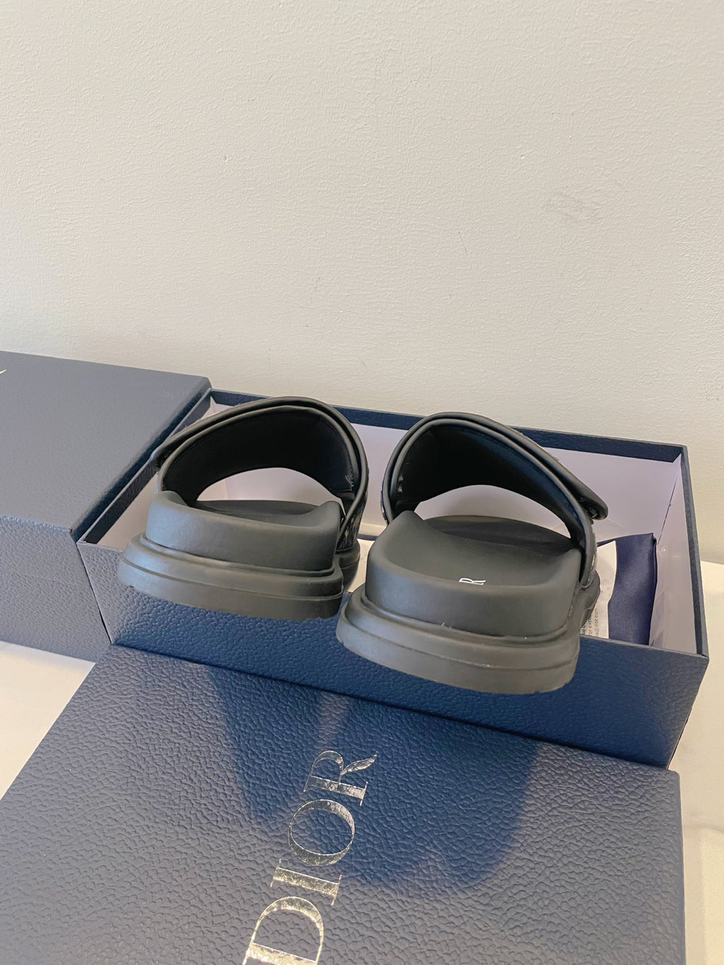 Dior slide sandals with smooth dark straps and cushioned footbed