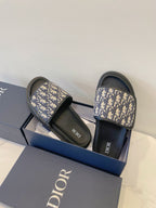 Dior slide sandals with navy monogram straps and black footbeds