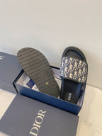 Dior slide sandals with patterned strap and textured rubber outsole
