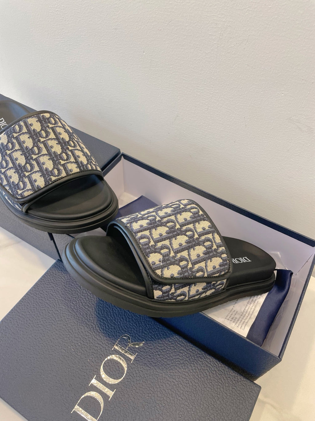 Dior slide sandals with navy monogram strap and black rubber sole