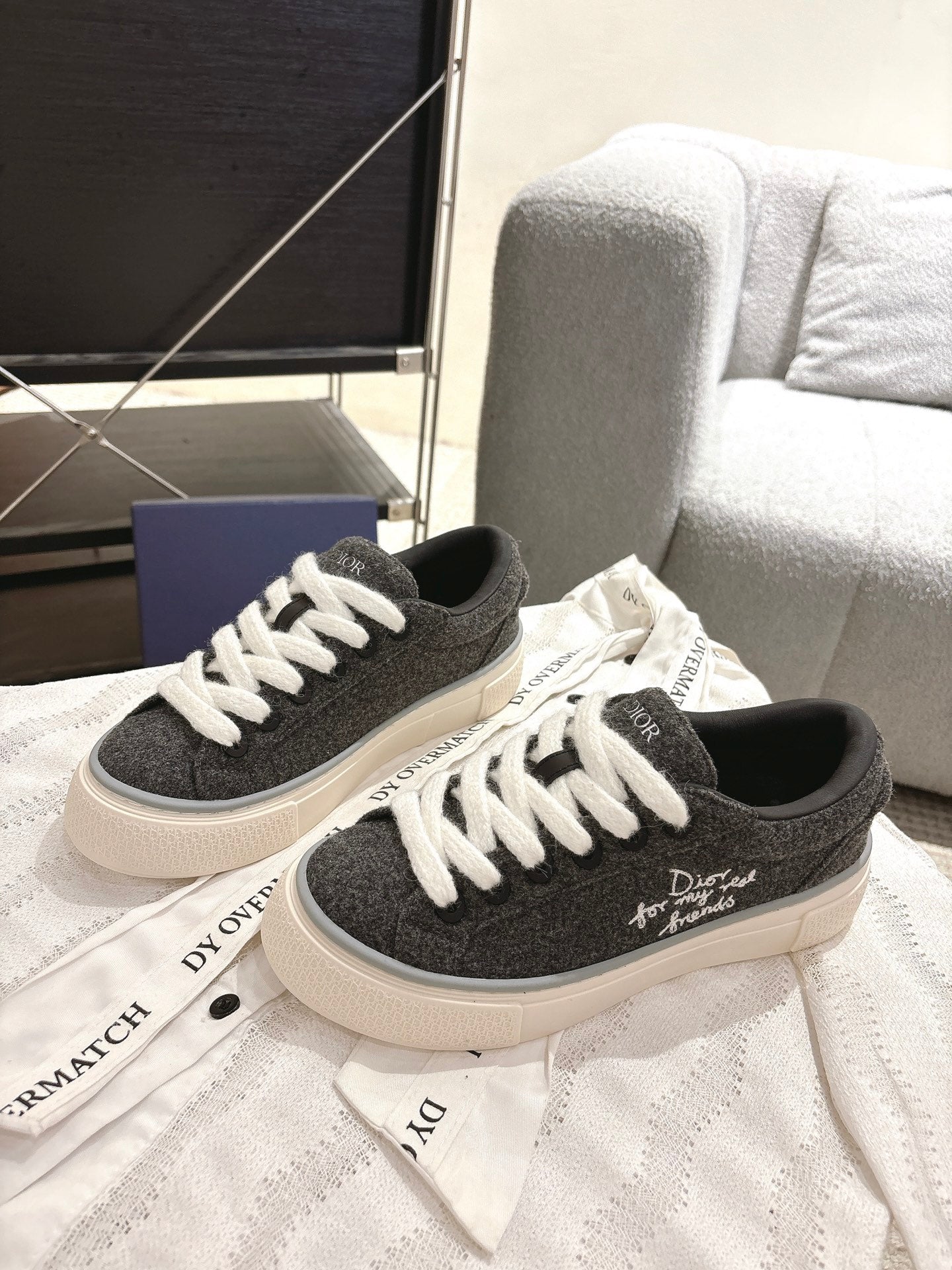 Unisex canvas sneakers with dark uppers, white laces, and white rubber sole