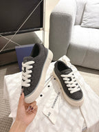 Unisex low-top sneakers front view, dark gray uppers with white laces and sole