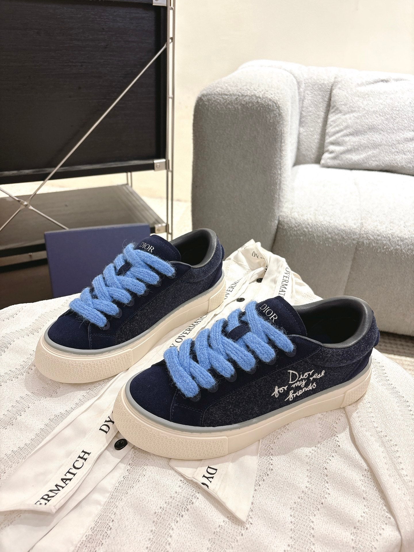 Navy and light blue lace low-top sneakers with textured white sole, DIOR logo on tongue