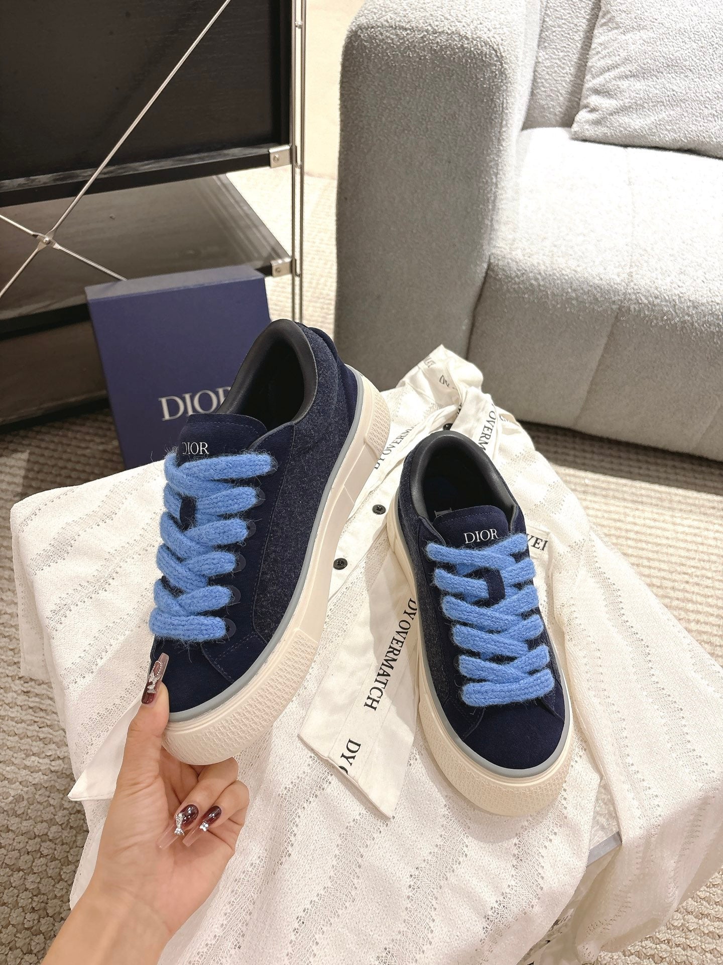 Navy lace-up sneakers with light blue laces and white rubber sole, DIOR print on tongue