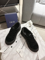 Black Dior lace-up sneakers, side view with branded insole and patterned laces