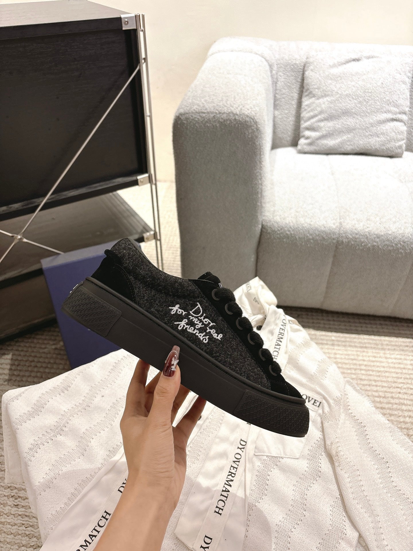 Black Dior lace-up sneakers, side view with logo embroidery on textured fabric