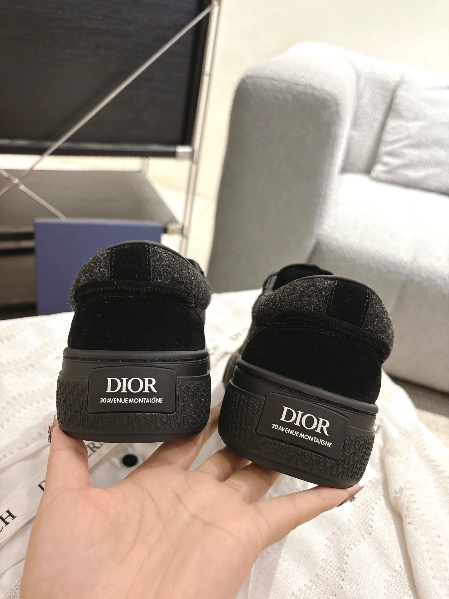 Black Dior sneakers with back heel tab, embossed logo on heel and lace closure