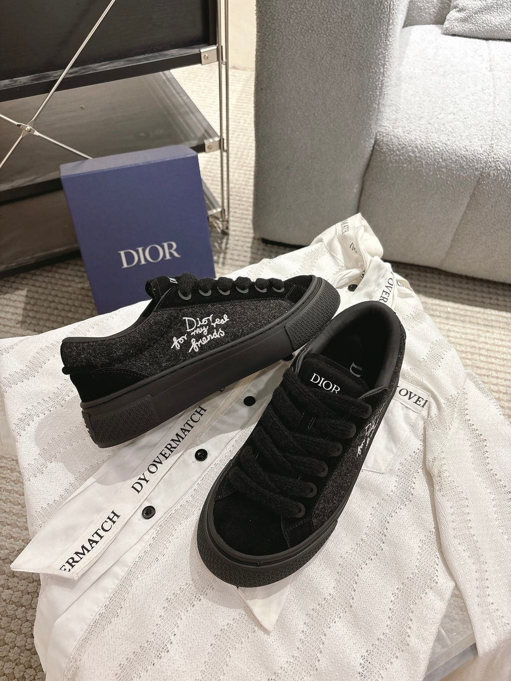 Black Dior low-top sneakers, side lettering logo and lace-up front on white cloth