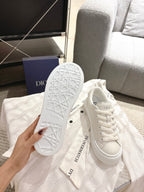White Dior sneakers bottom view, textured outsole with tread pattern