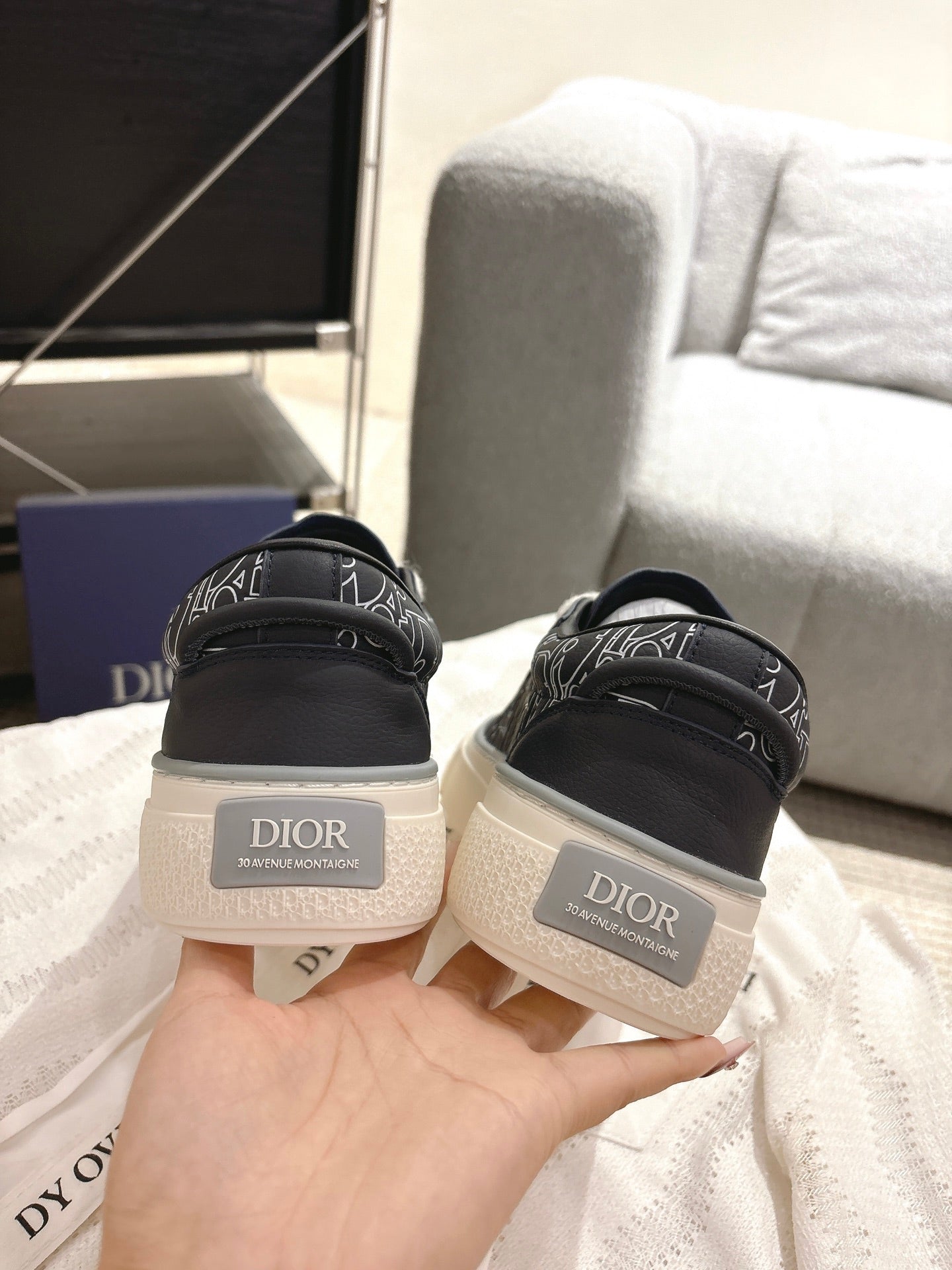 Dior unisex sneakers from heel, dark uppers with white logo patch on back