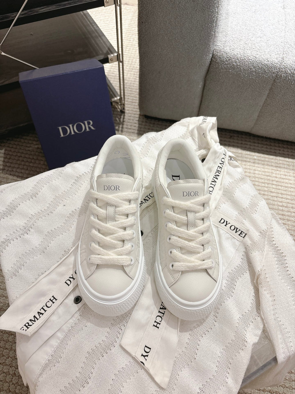 White Dior unisex sneakers with lace-up front and textured uppers
