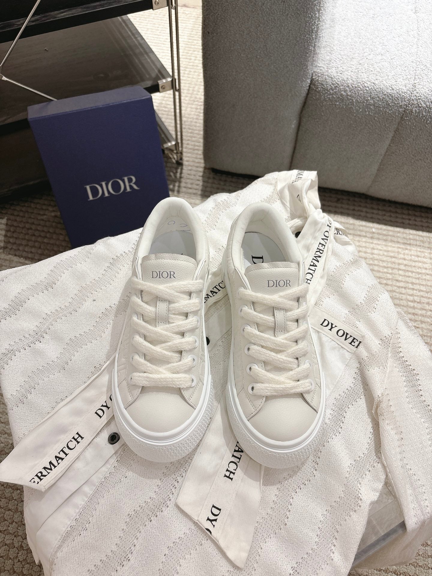 White Dior unisex sneakers with lace-up front and textured uppers
