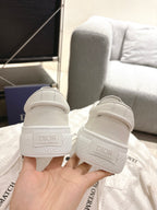 White Dior sneakers heel view with embossed logo on the back tab