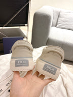 Light beige sneakers heel view with Dior label and cushioned white collar
