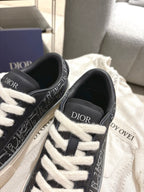 Dior unisex sneakers, close-up of black uppers with white laces and Dior branding