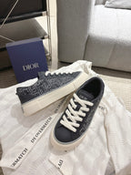 Dior unisex sneakers, black low-top with white lace-up and patterned side stripe