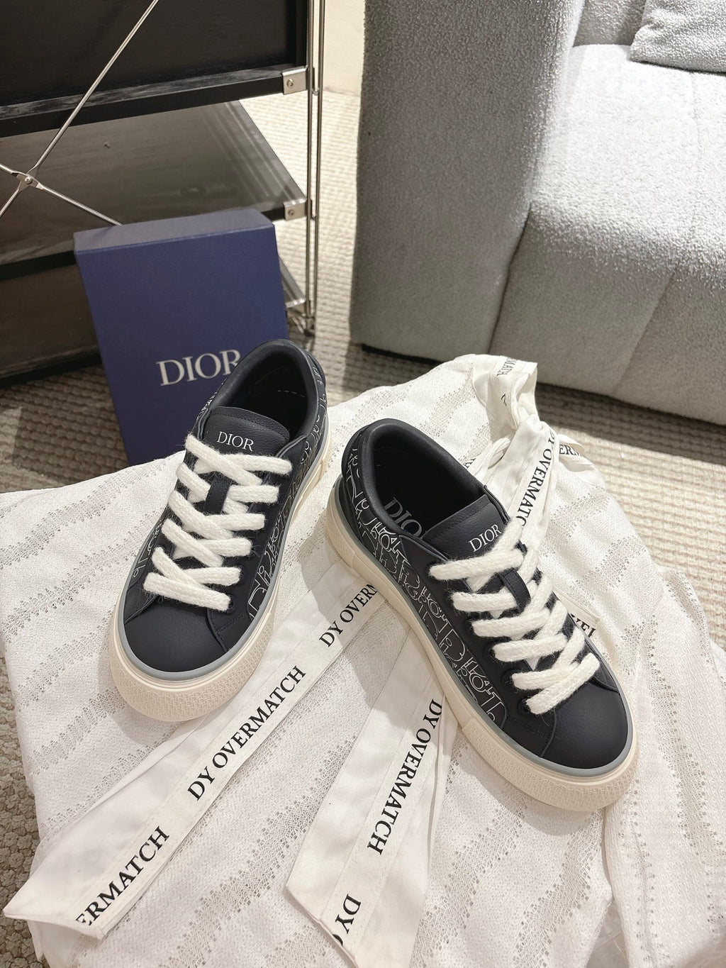 Dior unisex sneakers on dust bag, dark navy with white laces and logo print