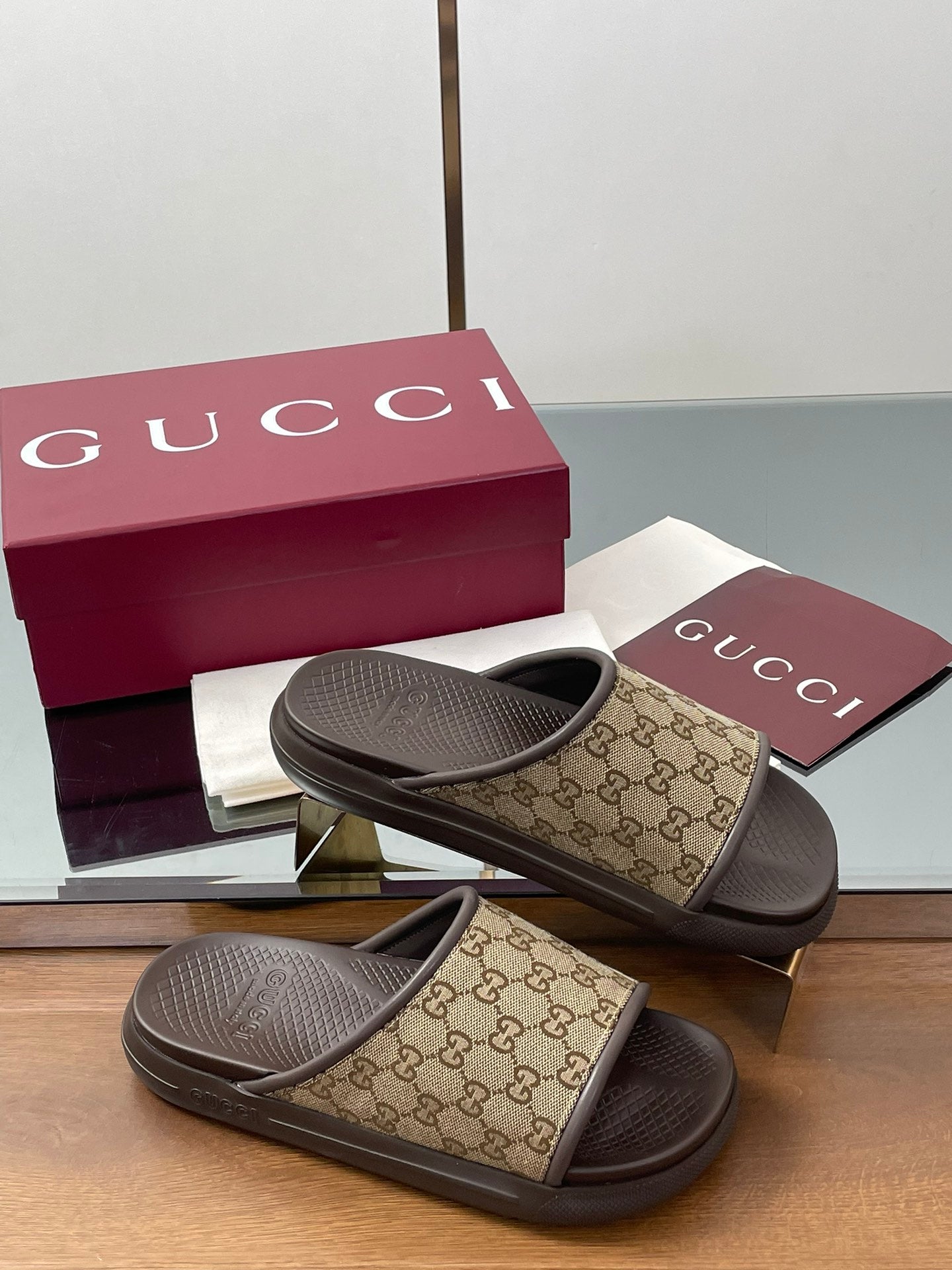Gucci slide sandals in tan GG canvas with dark rubber footbed and strap