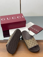 Gucci slide sandals showing textured dark rubber outsole beneath GG upper