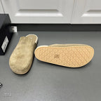 Taupe suede slide sandals with textured outsole featuring geometric pattern