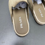 Taupe suede slide sandals showing PRADA logo on inner footbeds
