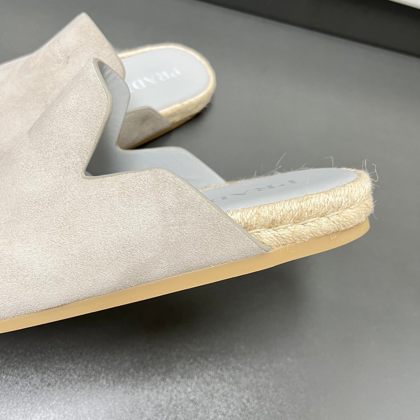 Prada light beige slip-on mule with jute-textured trim and thick sole edge