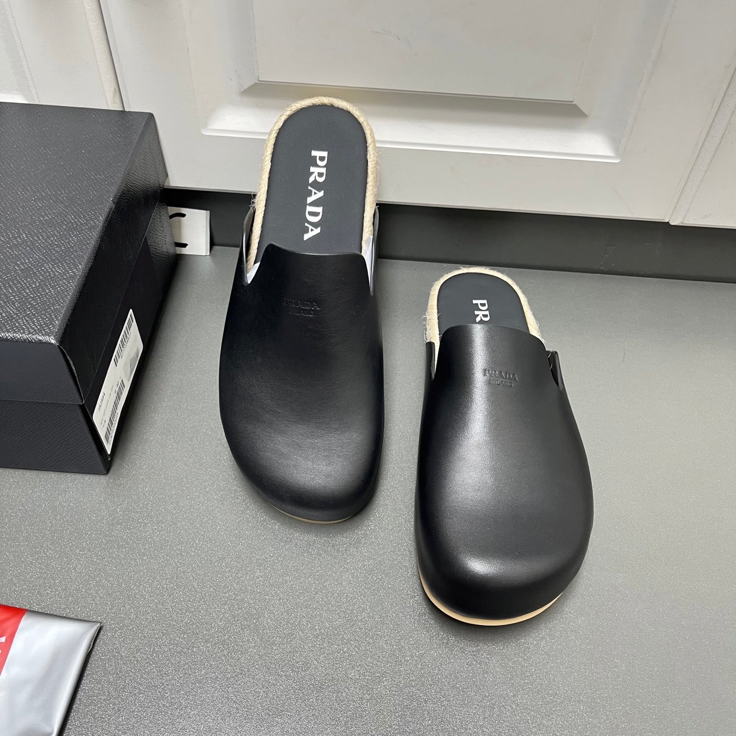 Prada leather slide sandals, black with shearling trim and cushioned footbed