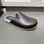 Prada black slip-on slide sandal with curved upper, beige shearling and tan trim