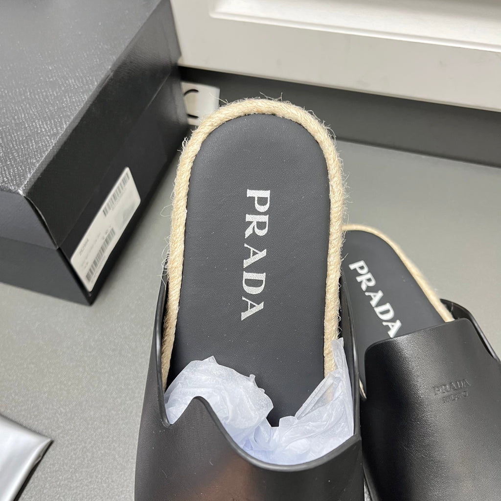 Prada black slide sandal with PRADA-printed insole and beige shearling lining
