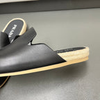 Prada black slide sandal with cutout vamp and braided jute midsole, shearling trim