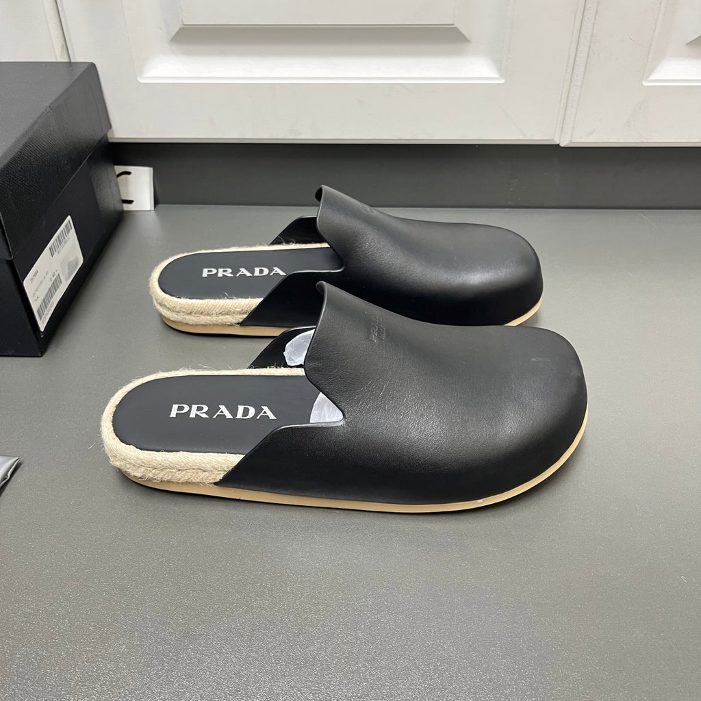 Prada black slide sandals with PRADA logo footbeds and beige shearling trim