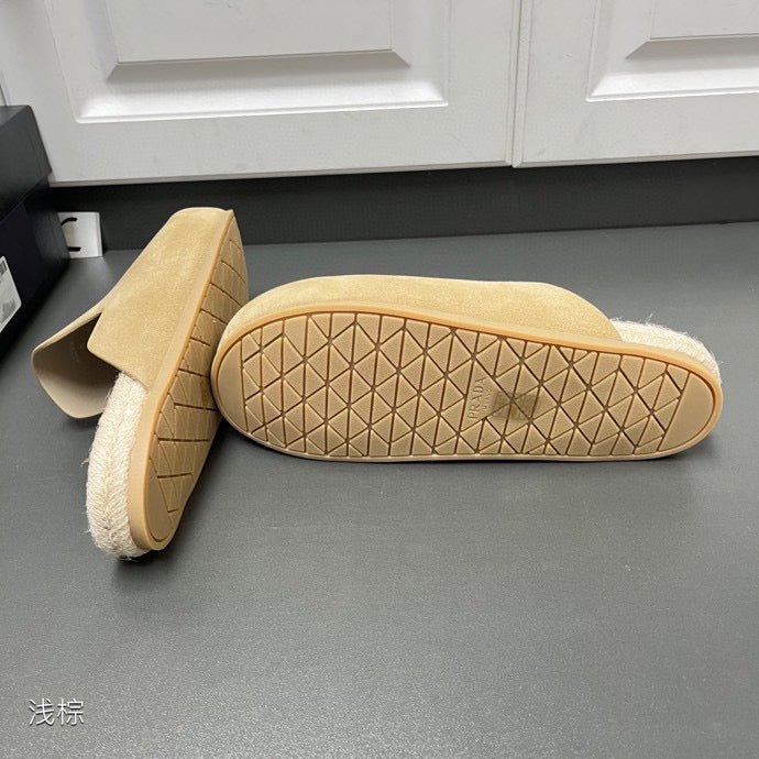 Prada slip-on sandal outsole with tan textured tread and curved side profile