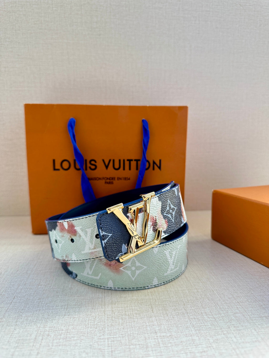 Louis Vuitton belt with blue-and-light monogram print and gold-toned buckle on display