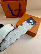 Louis Vuitton belt close-up: blue-and-light monogram strap with stud holes