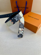 Louis Vuitton belt with blue-and-light monogram print and silver buckle, angled on surface