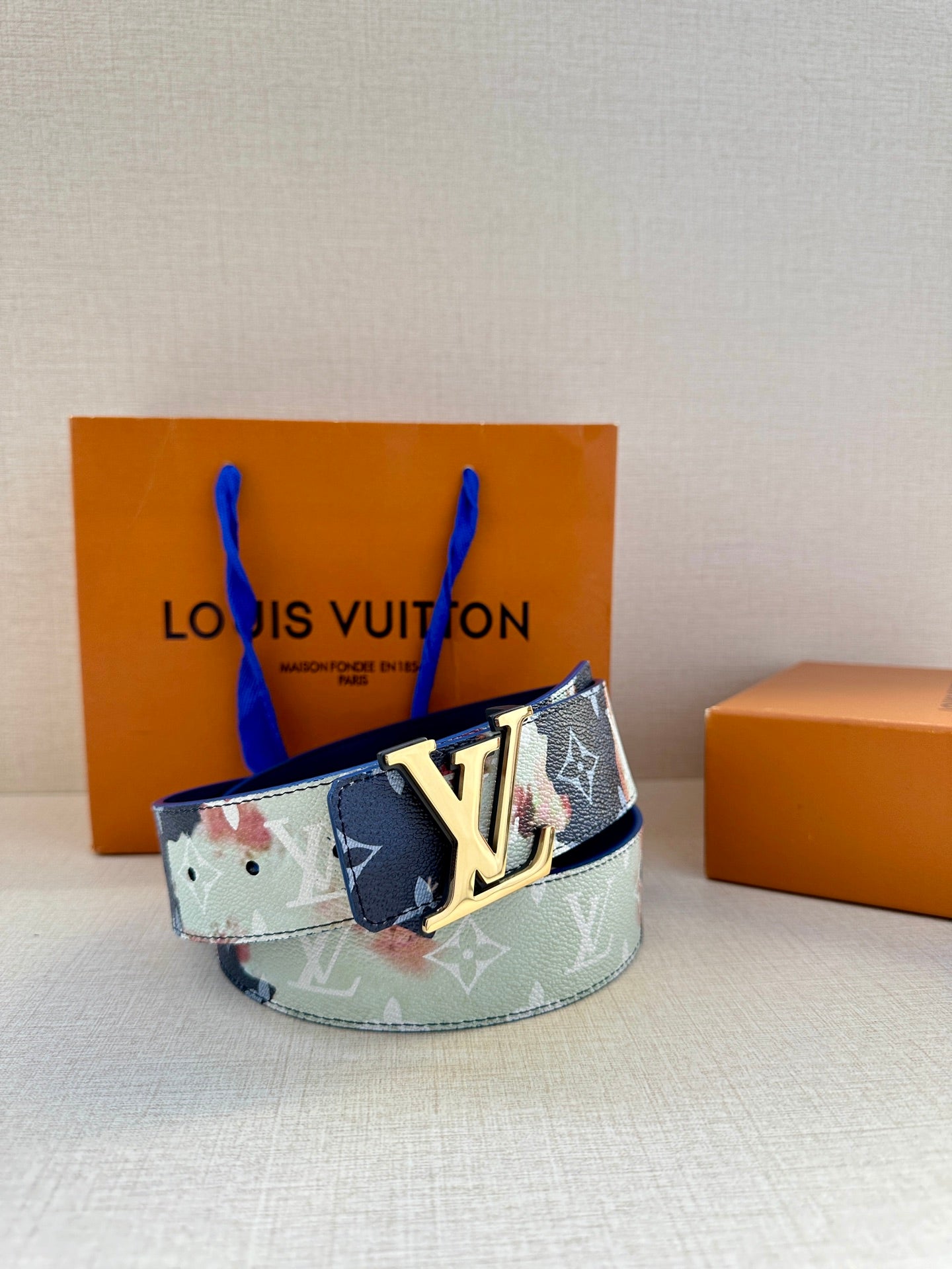 Louis Vuitton belt worn look: multicolor patchwork strap with gold LV buckle front