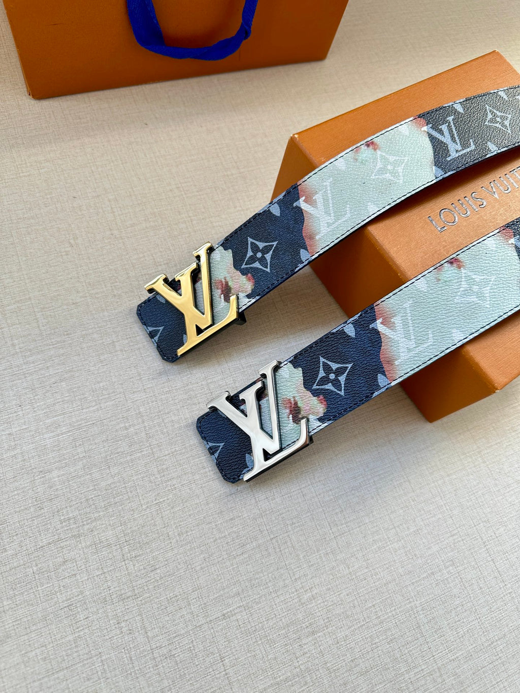 Louis Vuitton belt pair view: multicolor monogram strap with gold LV buckle and holes