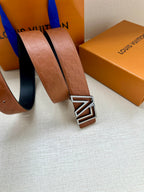 Tan leather belt with textured pattern and gold-tone LV buckle, close-up