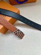 Dark leather belt with prong holes and silver-tone LV buckle, angled view