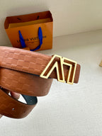 Tan patterned leather belt with gold-tone LV buckle and adjustable keeper