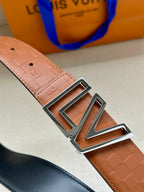 Tan patterned leather belt with silver-tone buckle and LV monogram