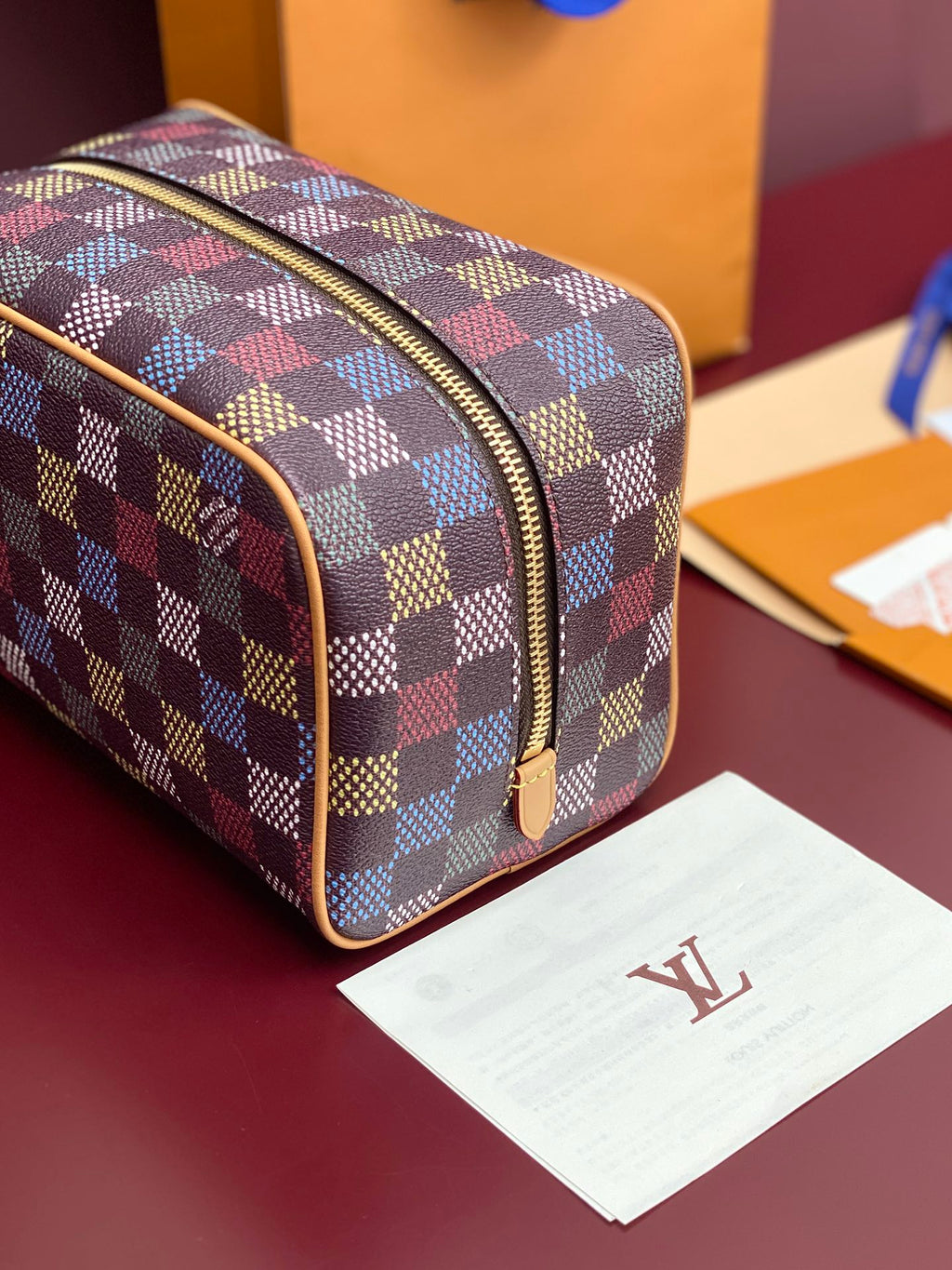 Louis Vuitton check-pattern small bag with curved top zipper and tan piping