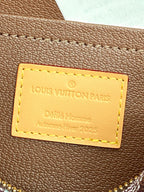 Louis Vuitton Paris label on brown leather flap with yellow-stitched border