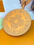 Gold round globe charm with 'LOUIS VUITTON' and 'PARIS' lettering