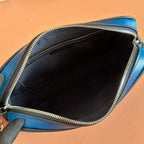 Gucci bag open top showing black interior lining and gold-tone zipper edge