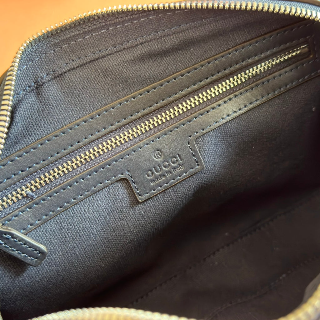 Gucci bag interior logo patch on blue leather with gold-tone zipper and stitching