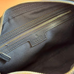 Gucci bag interior logo patch on blue leather with gold-tone zipper and stitching