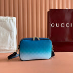 Gucci bag with blue gradient body, front top handle, side zips, and black strap